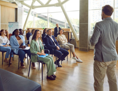 Group of people having a business training with a professional coach.